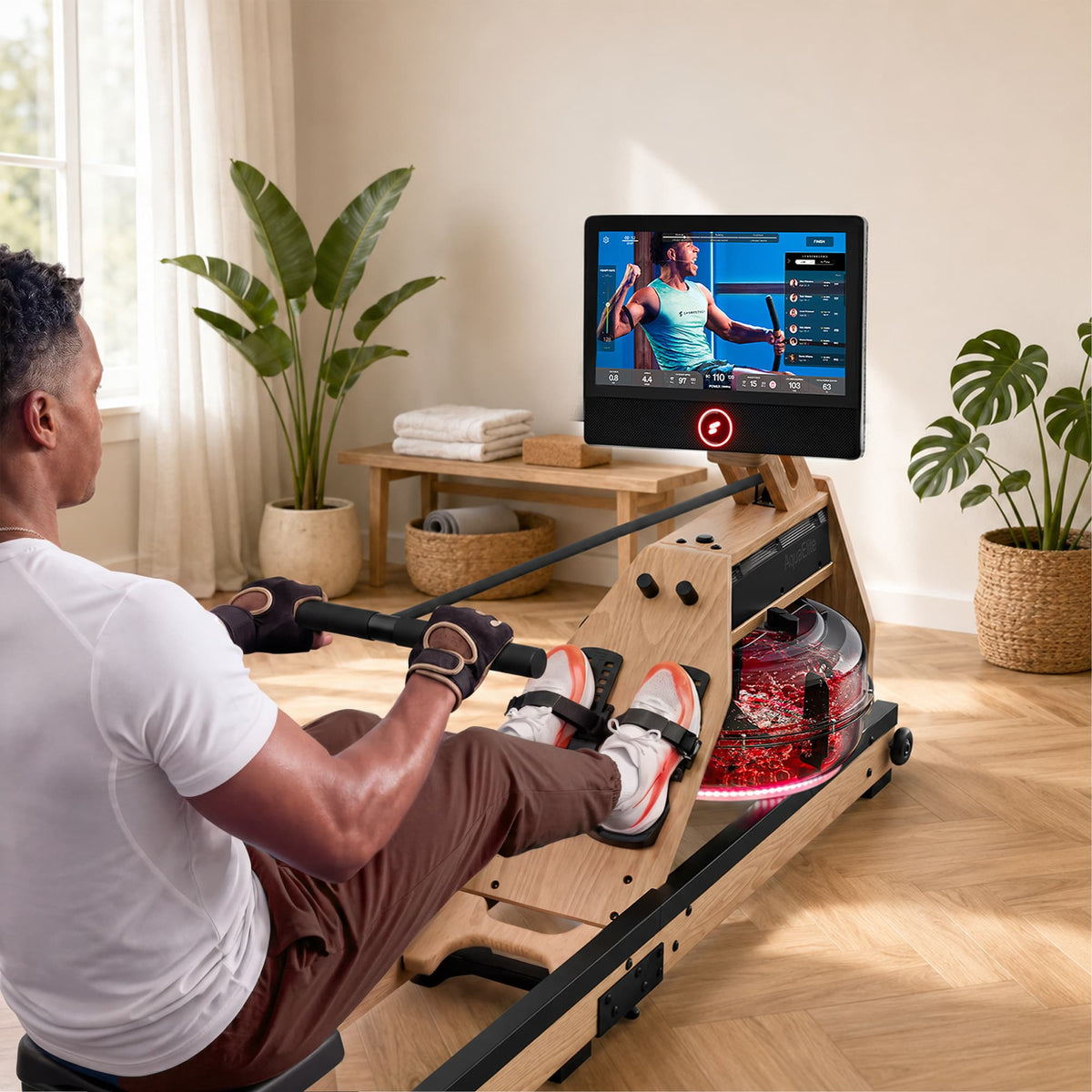 Mann rudert am hellbraunen Aqua Elite, rot beleuchteter Tank und Trainervideo auf 21,5-Zoll-Display