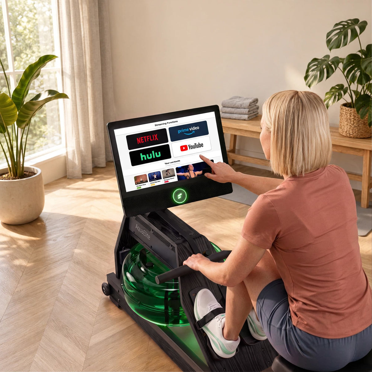 Frau tippt am schwarzen Aqua Elite auf die Streaming-Auswahl des 21,5-Zoll-Displays, Tank leuchtet grün