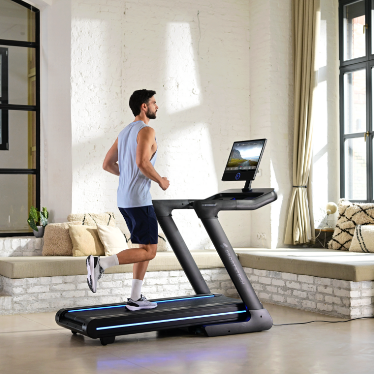 Mann beim Heimtraining auf einem Laufband im Wohnzimmer