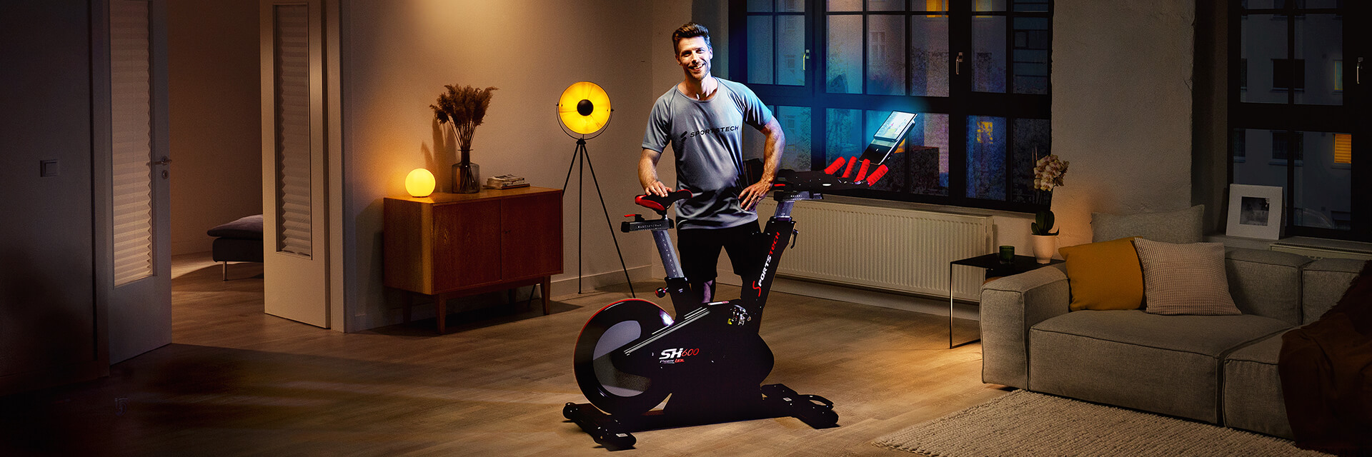 Schwarzes Laufband F10 Sportstech Frau in Sportbekleidung läuft auf schwarzem Laufband F10 im Wohnzimmer